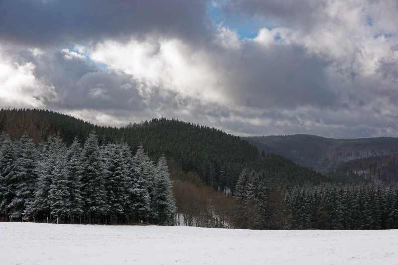 View from Hesborner Weg, Winterberg, on snowy mountain landscape and clouds
